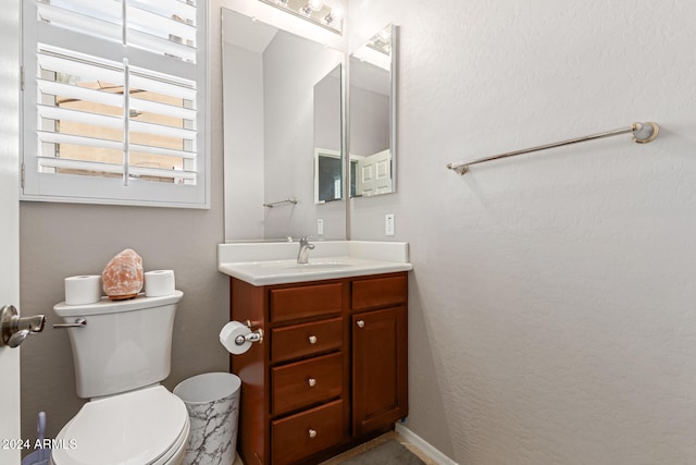 bathroom featuring toilet and vanity