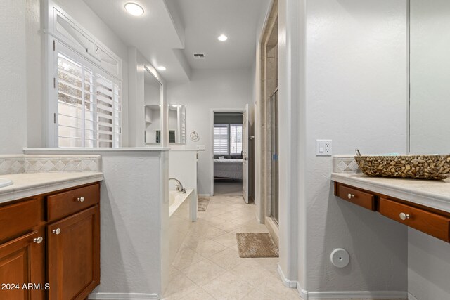 bathroom with vanity, separate shower and tub, and tile patterned flooring