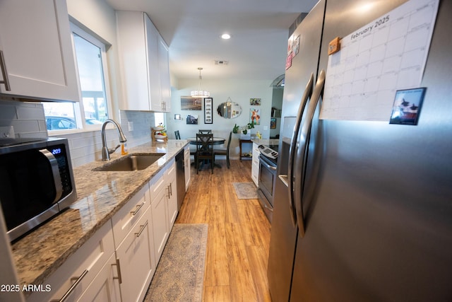 kitchen with white cabinetry, sink, and appliances with stainless steel finishes