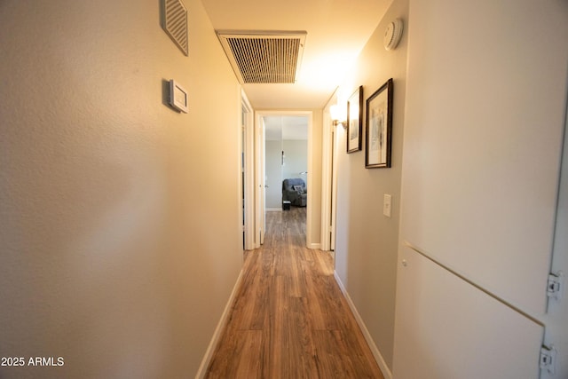 hallway with hardwood / wood-style flooring