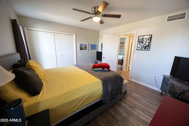 bedroom with a closet, dark hardwood / wood-style floors, and ceiling fan