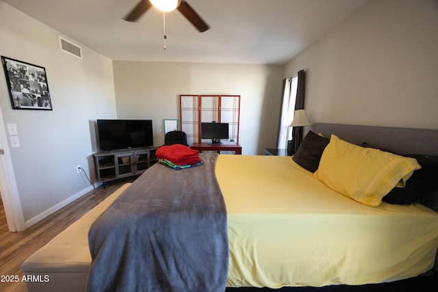 bedroom with dark hardwood / wood-style floors and ceiling fan