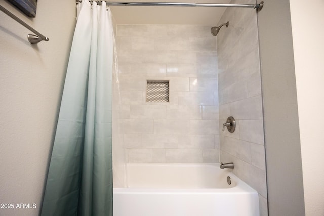 bathroom with shower / tub combo with curtain