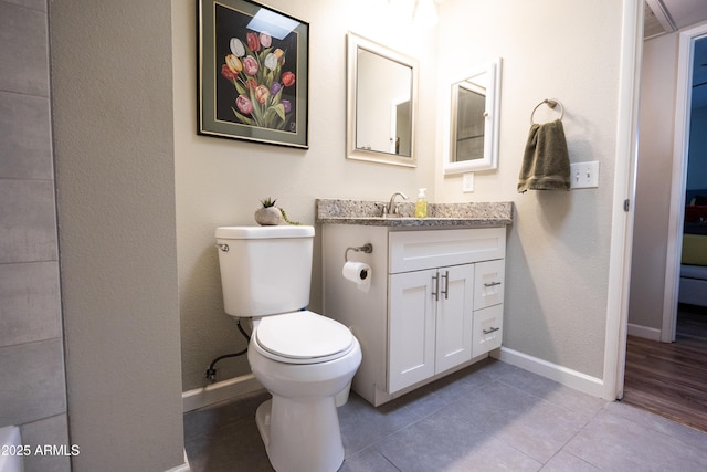 bathroom with vanity, tile patterned floors, and toilet