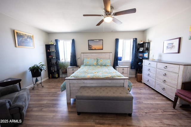 bedroom featuring ceiling fan, dark hardwood / wood-style floors, and multiple windows
