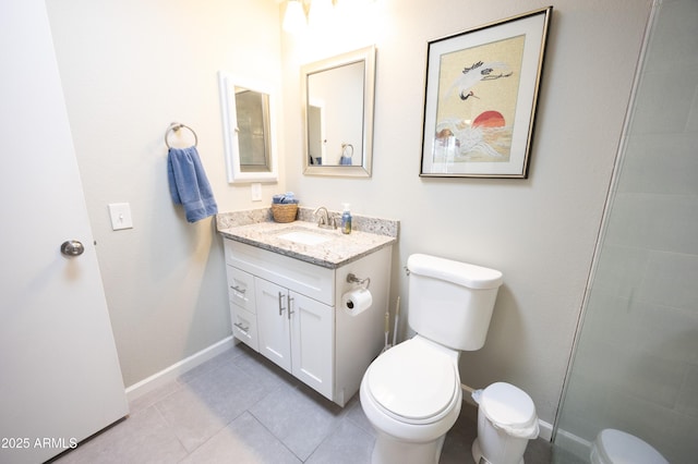 bathroom with vanity, tile patterned floors, and toilet