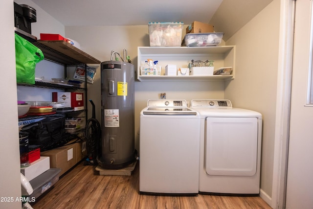 laundry room featuring water heater, light wood-type flooring, and washer and clothes dryer
