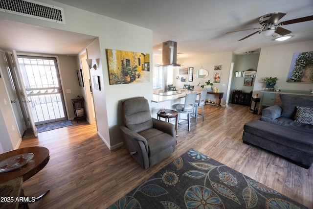 living room with ceiling fan and hardwood / wood-style floors