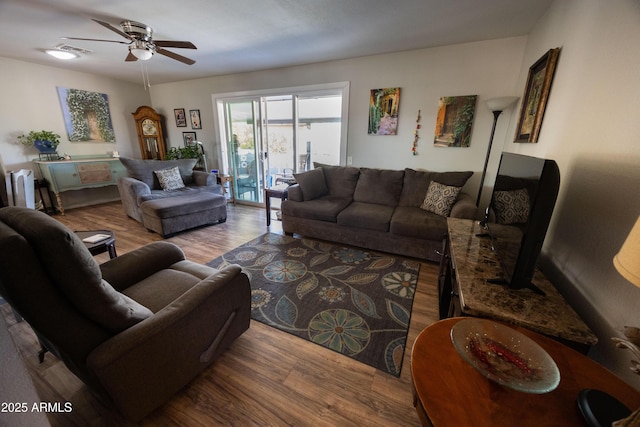 living room featuring hardwood / wood-style floors and ceiling fan