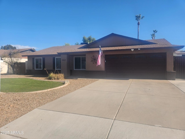 ranch-style home with a garage and a front lawn