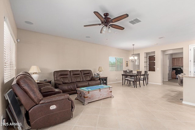 1410 W Popcorn Tree Ave, Queen Creek, AZ 85140 - living area featuring a chandelier, ceiling fan, light tile patterned floors, and baseboards