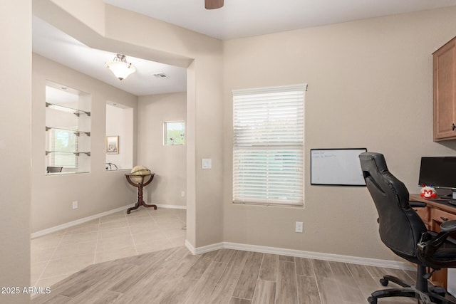 1410 W Popcorn Tree Ave, Queen Creek, AZ 85140 - office with light wood-style floors, baseboards, and a ceiling fan