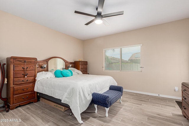 1410 W Popcorn Tree Ave, Queen Creek, AZ 85140 - bedroom featuring light wood-style flooring, baseboards, and ceiling fan