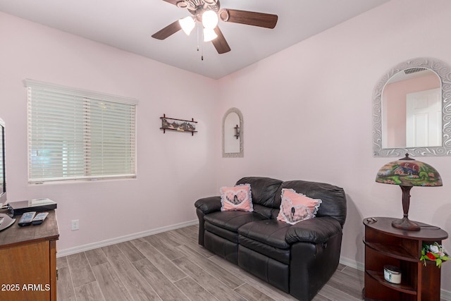 1410 W Popcorn Tree Ave, Queen Creek, AZ 85140 - living area featuring light wood-style floors, a ceiling fan, and baseboards