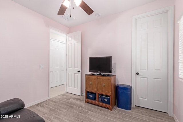 1410 W Popcorn Tree Ave, Queen Creek, AZ 85140 - living area with a ceiling fan, light wood-style flooring, and baseboards