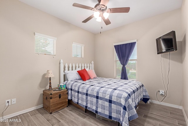 1410 W Popcorn Tree Ave, Queen Creek, AZ 85140 - bedroom featuring multiple windows, wood finished floors, and baseboards