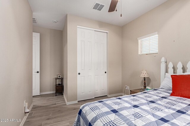 1410 W Popcorn Tree Ave, Queen Creek, AZ 85140 - bedroom featuring a closet, light wood-type flooring, baseboards, and a ceiling fan
