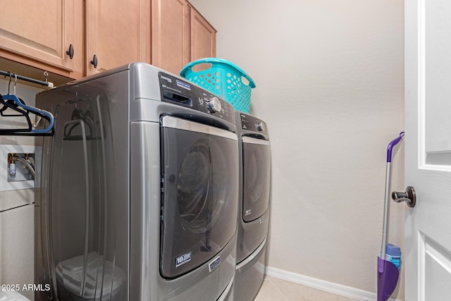 1410 W Popcorn Tree Ave, Queen Creek, AZ 85140 - laundry area featuring washing machine and clothes dryer, cabinet space, baseboards, and light tile patterned floors