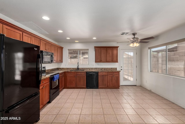2906 W Irma Ln, Phoenix, AZ 85027 - kitchen featuring black appliances, a sink, dark stone countertops, brown cabinetry, and a ceiling fan