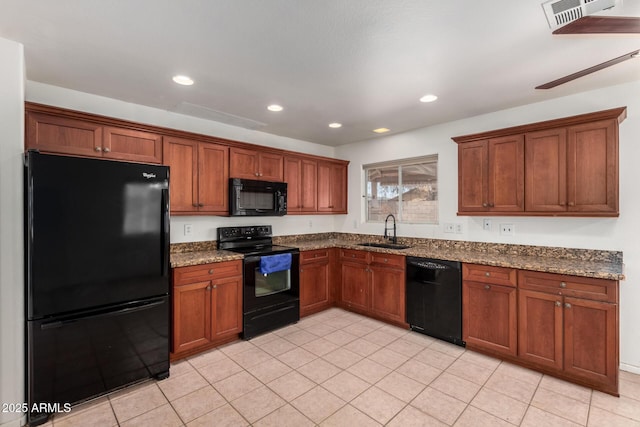 2906 W Irma Ln, Phoenix, AZ 85027 - kitchen with black appliances, a sink, dark stone countertops, brown cabinets, and recessed lighting