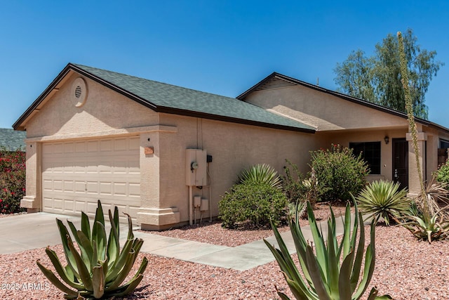 2906 W Irma Ln, Phoenix, AZ 85027 - view of property exterior featuring stucco siding, an attached garage, concrete driveway, and a shingled roof