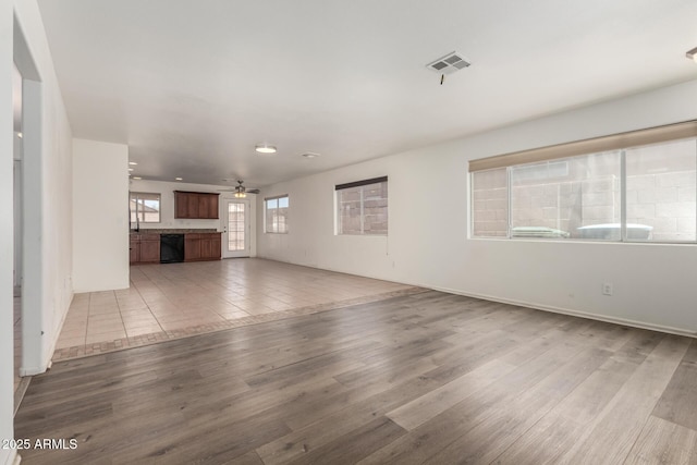 2906 W Irma Ln, Phoenix, AZ 85027 - unfurnished living room featuring wood finished floors, a ceiling fan, and baseboards