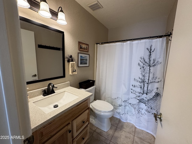 full bath featuring visible vents, a textured wall, toilet, tile patterned floors, and vanity