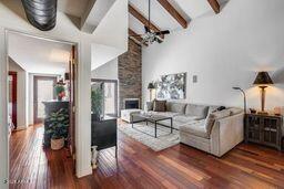 4242 N 44th St, Phoenix, AZ 85018 - living room with healthy amount of natural light, wood finished floors, a fireplace, and a chandelier