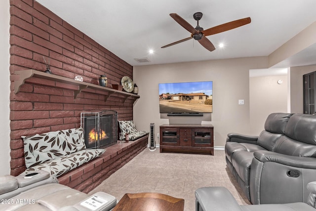 living room with ceiling fan and a fireplace