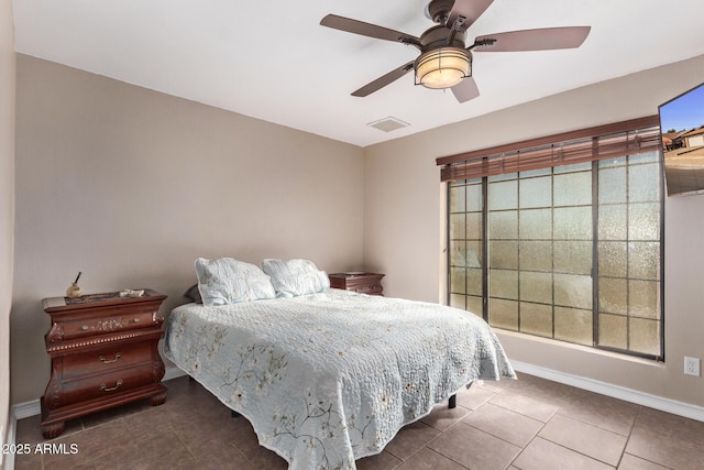 bedroom featuring dark tile patterned flooring and ceiling fan