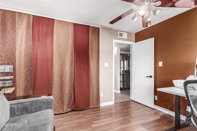 living area featuring ceiling fan and wood-type flooring