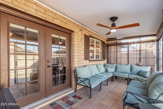 sunroom / solarium with ceiling fan and french doors