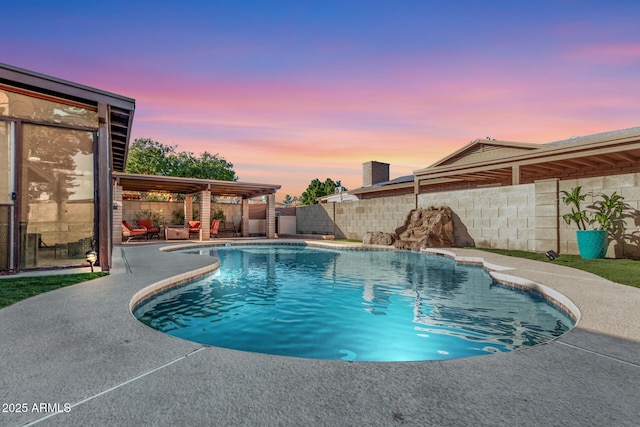 pool at dusk featuring a patio