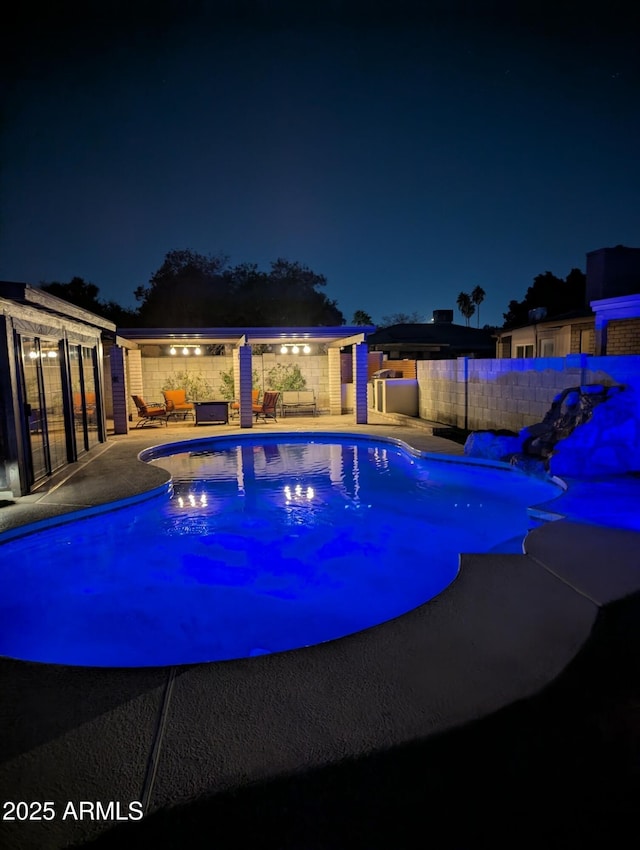 pool at night with a patio