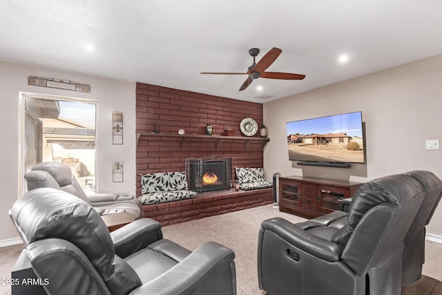 living room featuring light tile patterned floors, a brick fireplace, and ceiling fan