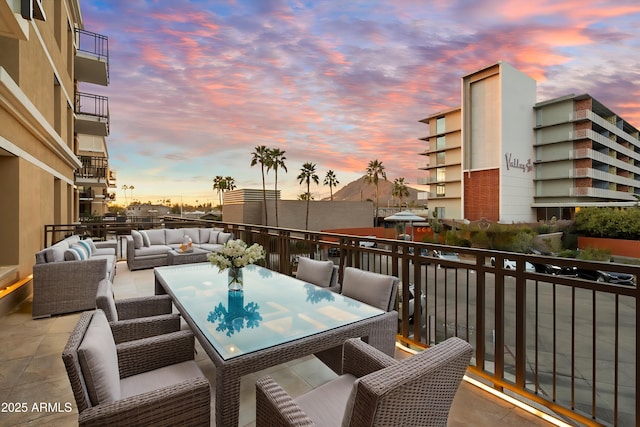 balcony at dusk featuring outdoor lounge area