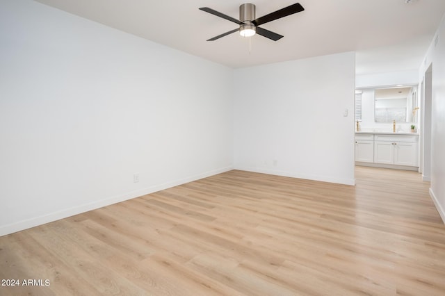 spare room featuring ceiling fan and light hardwood / wood-style flooring