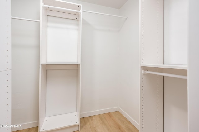 spacious closet with light hardwood / wood-style floors