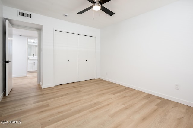 unfurnished bedroom featuring ceiling fan, a closet, and light hardwood / wood-style floors