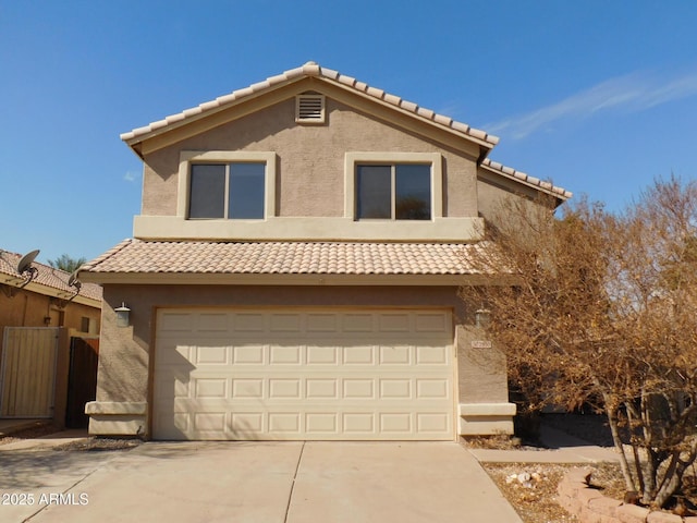 view of front of home with a garage, fence, concrete driveway, and stucco siding