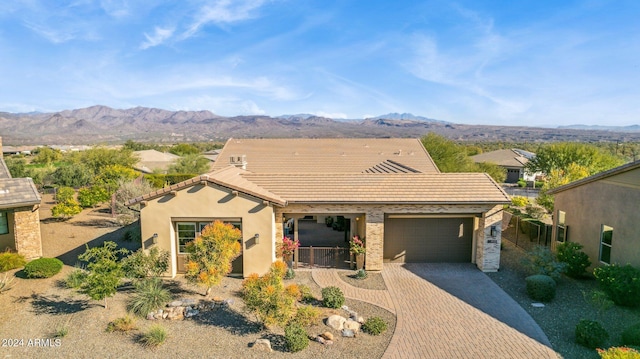 view of front facade featuring a mountain view and a garage