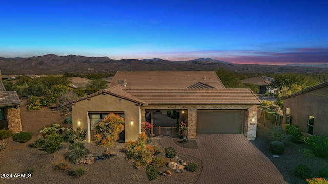 view of front of home featuring a mountain view and a garage