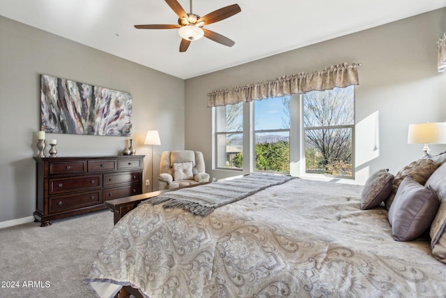 bedroom with ceiling fan and light colored carpet