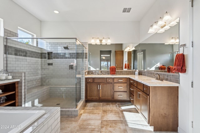 bathroom with shower with separate bathtub, vanity, and tile patterned floors