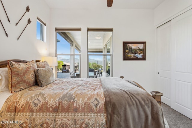 carpeted bedroom with access to outside, a closet, and ceiling fan