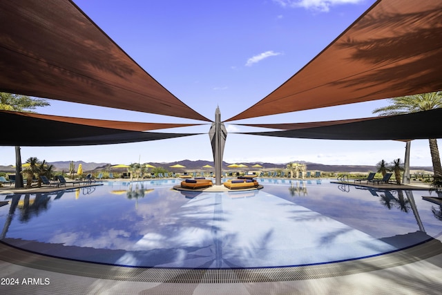 view of pool featuring a water and mountain view