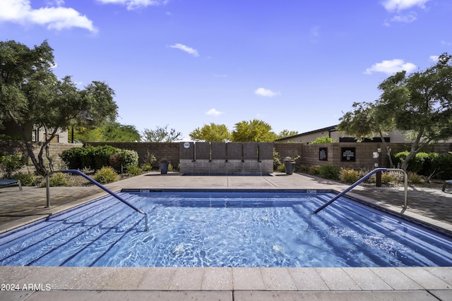 view of swimming pool with a patio area