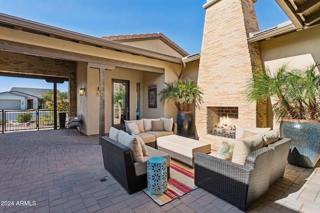 view of patio featuring an outdoor living space with a fireplace