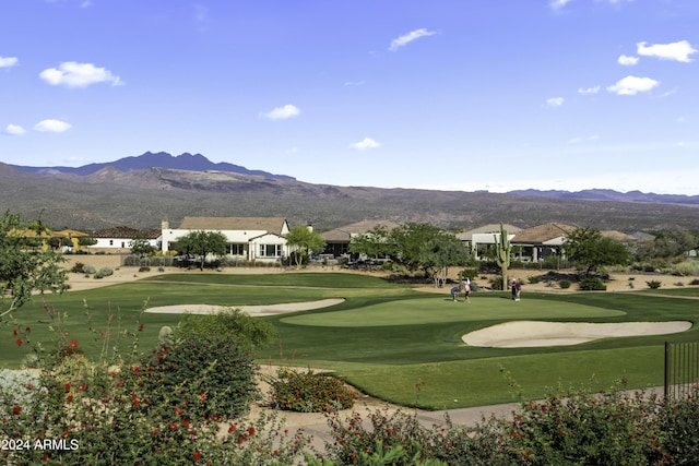 view of community with a mountain view and a yard