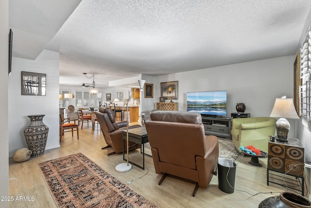 living room featuring a textured ceiling and light wood-type flooring